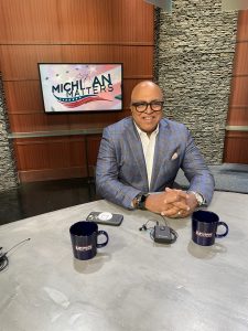 David Tarver in front of Michigan Matters poster